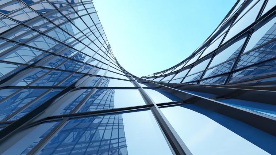 Modern glass office buildings viewed from below, featuring curved blue-tinted façades, reflective windows and contemporary architectural lines against a clear sky.